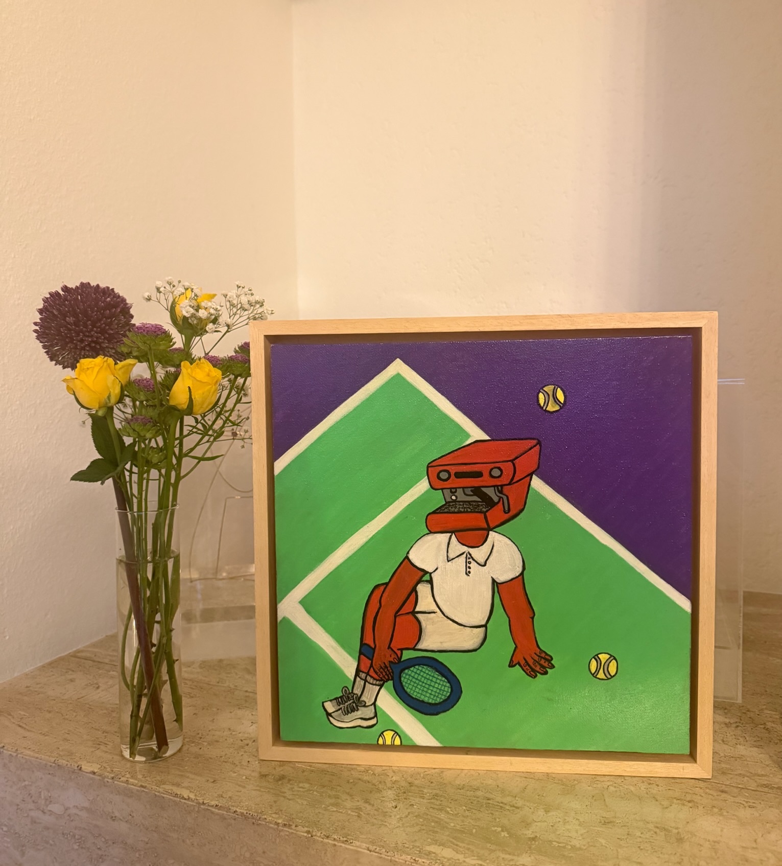 Framed pop-art tennis player painting beside a bud vase of yellow roses, allium and gypsophila