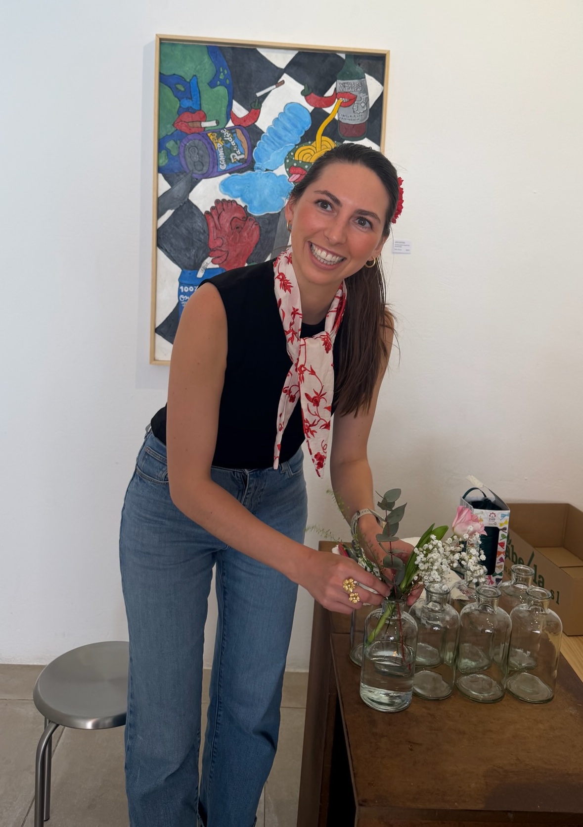 Rahel Dana, founder of Flower Lab, arranging blooms in glass vessels