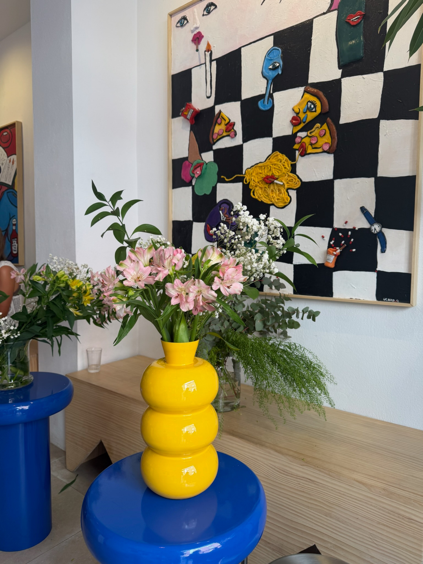Yellow sculptural vase with pink alstroemeria